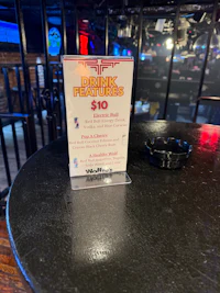 a ticket is sitting on a table in a bar